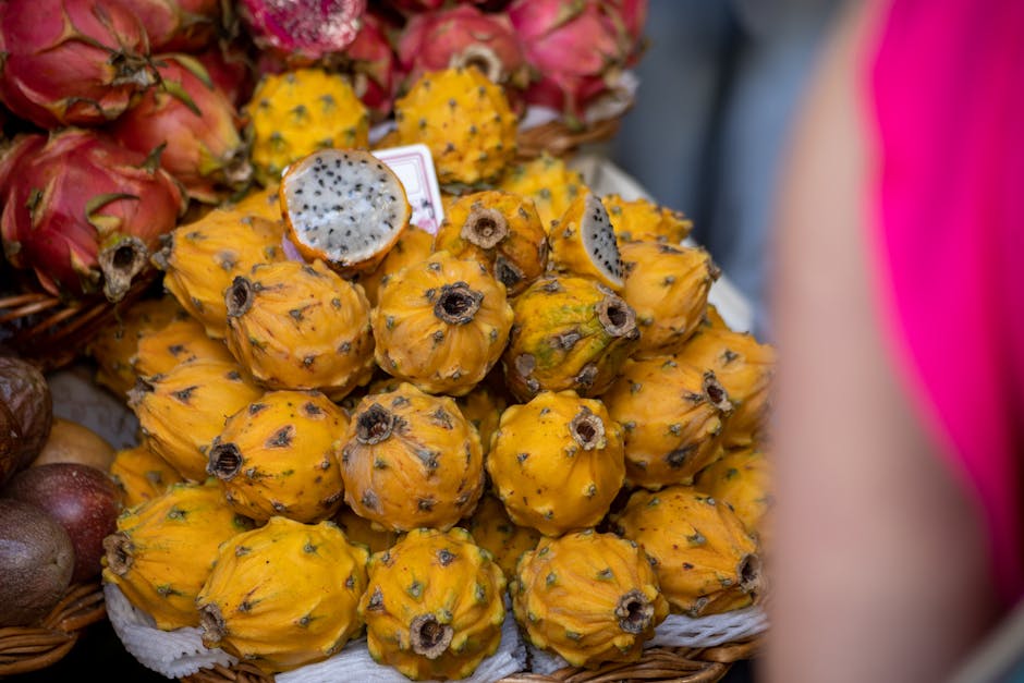 Close-up image of yellow pitaya fruits in a market setting, showcasing vibrant colors and exotic appeal.